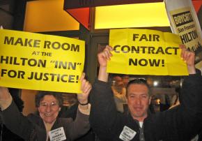 HERE Local 2 member and supporter are ushered out of a Hilton in San Francisco after a direct action
